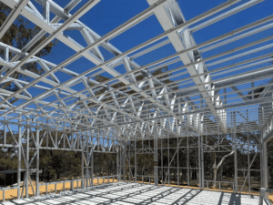Steel truss installation on industrial warehouse roof