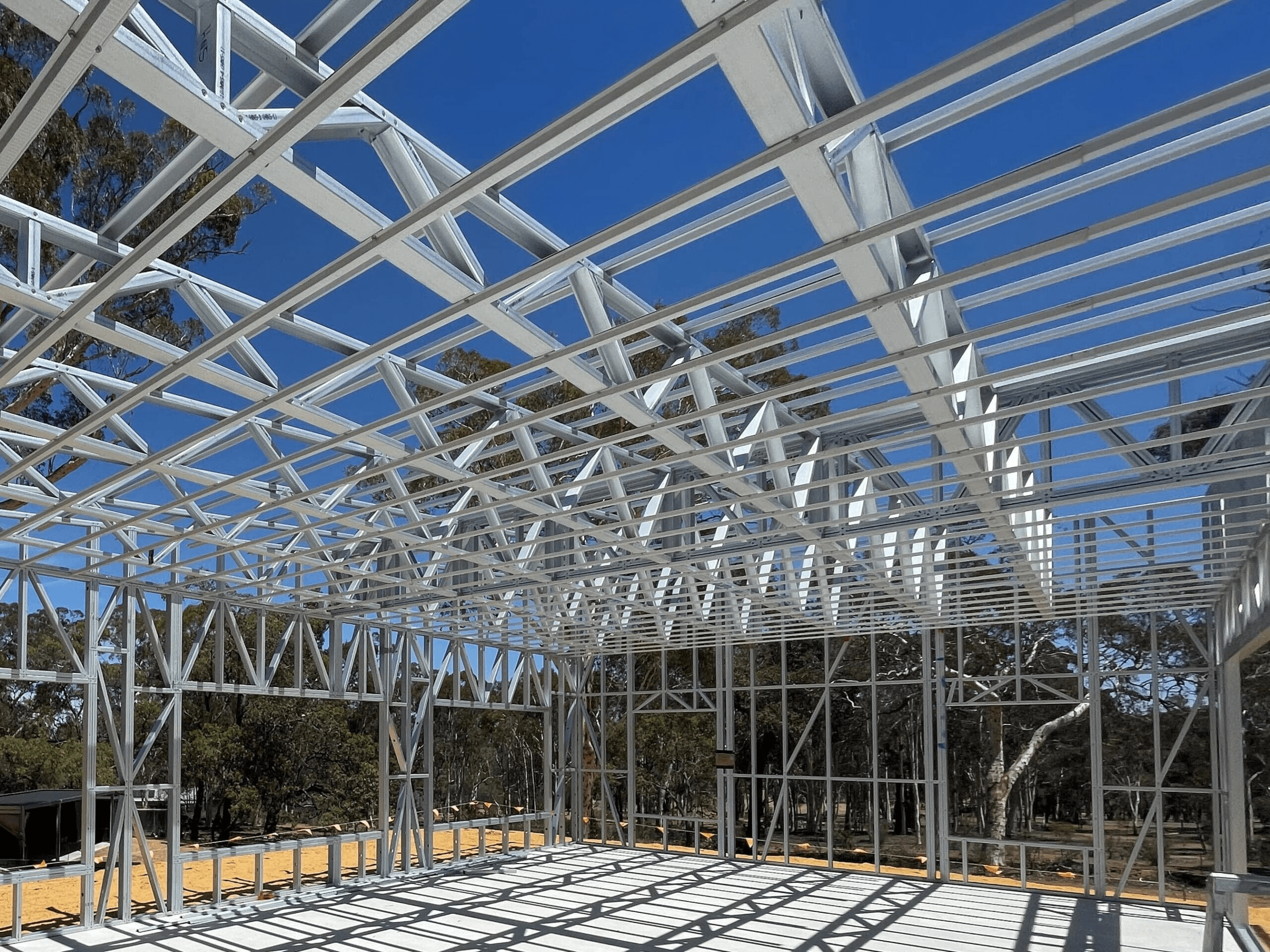 Steel truss installation on industrial warehouse roof